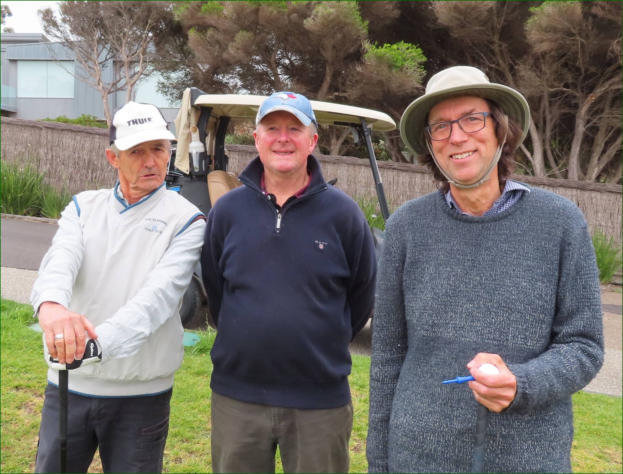 A group of men standing on a grass field

Description automatically generated