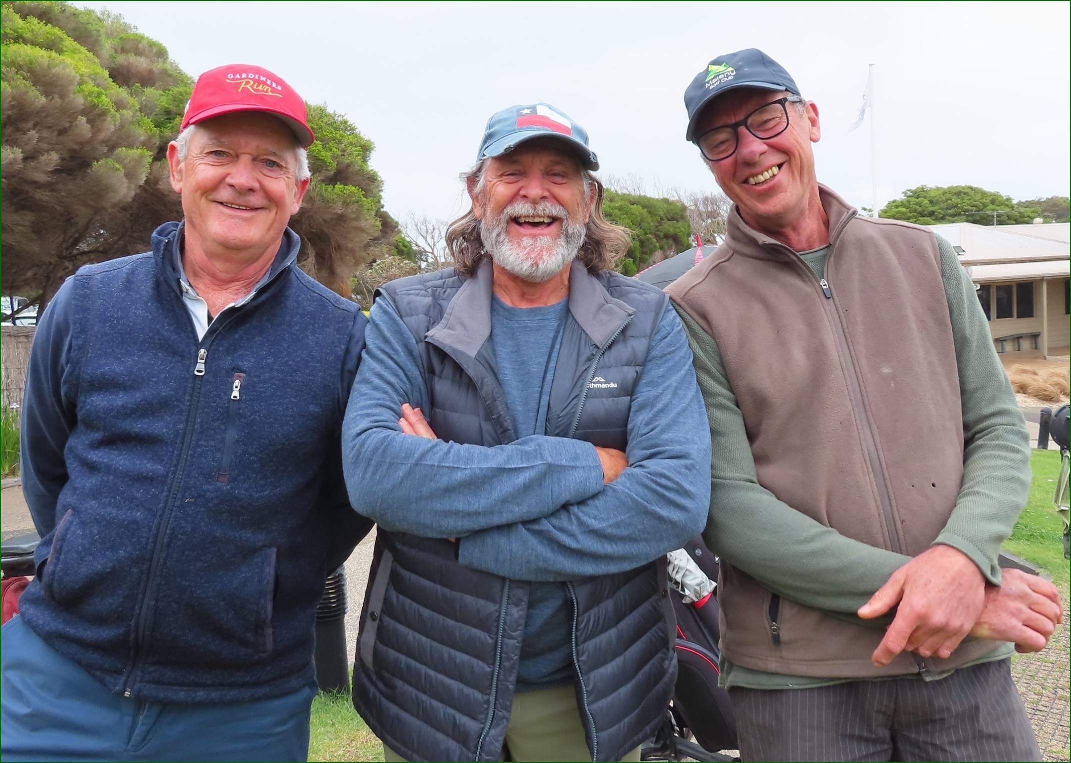 A group of men standing together smiling

Description automatically generated