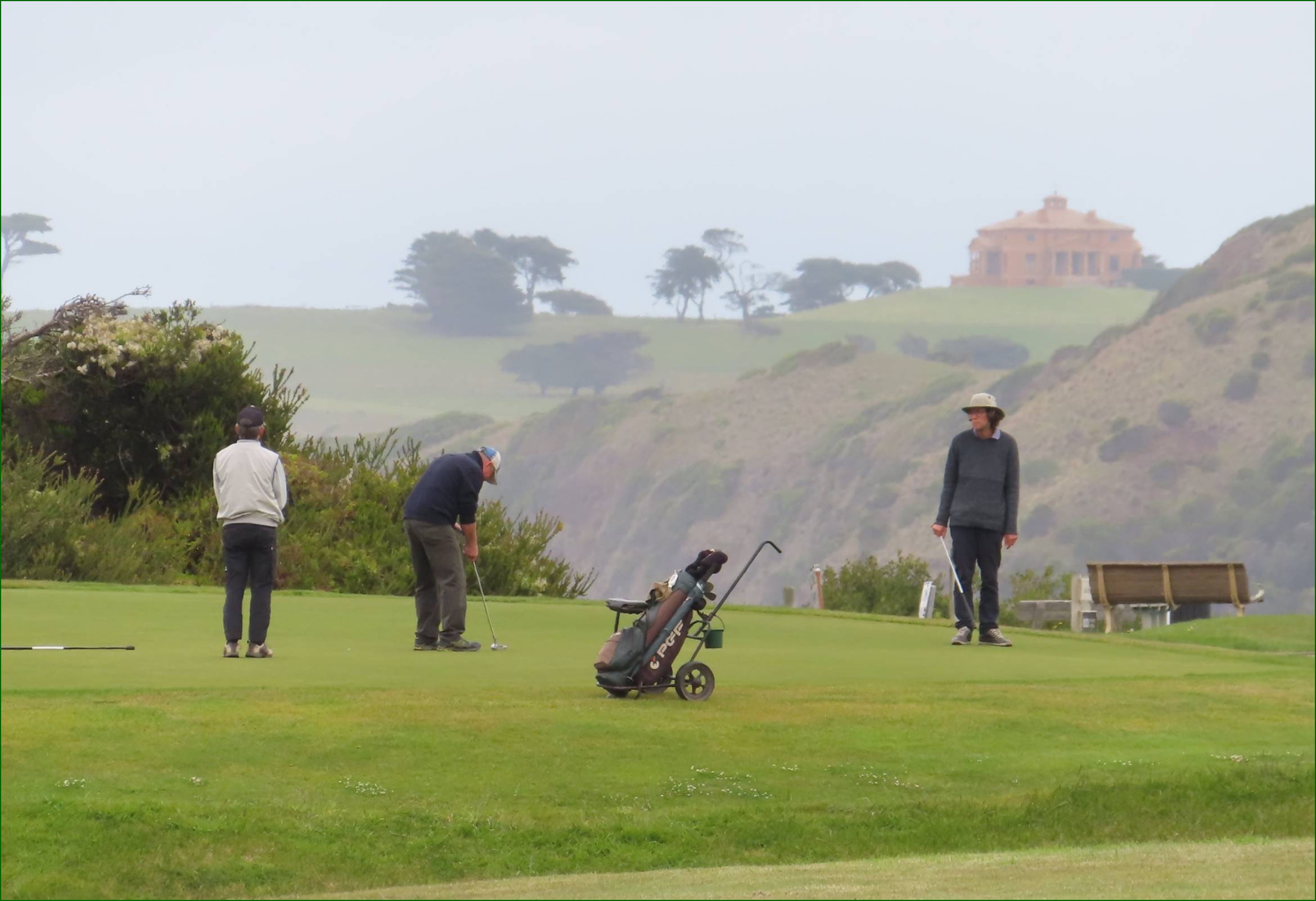 A group of people playing golf

Description automatically generated