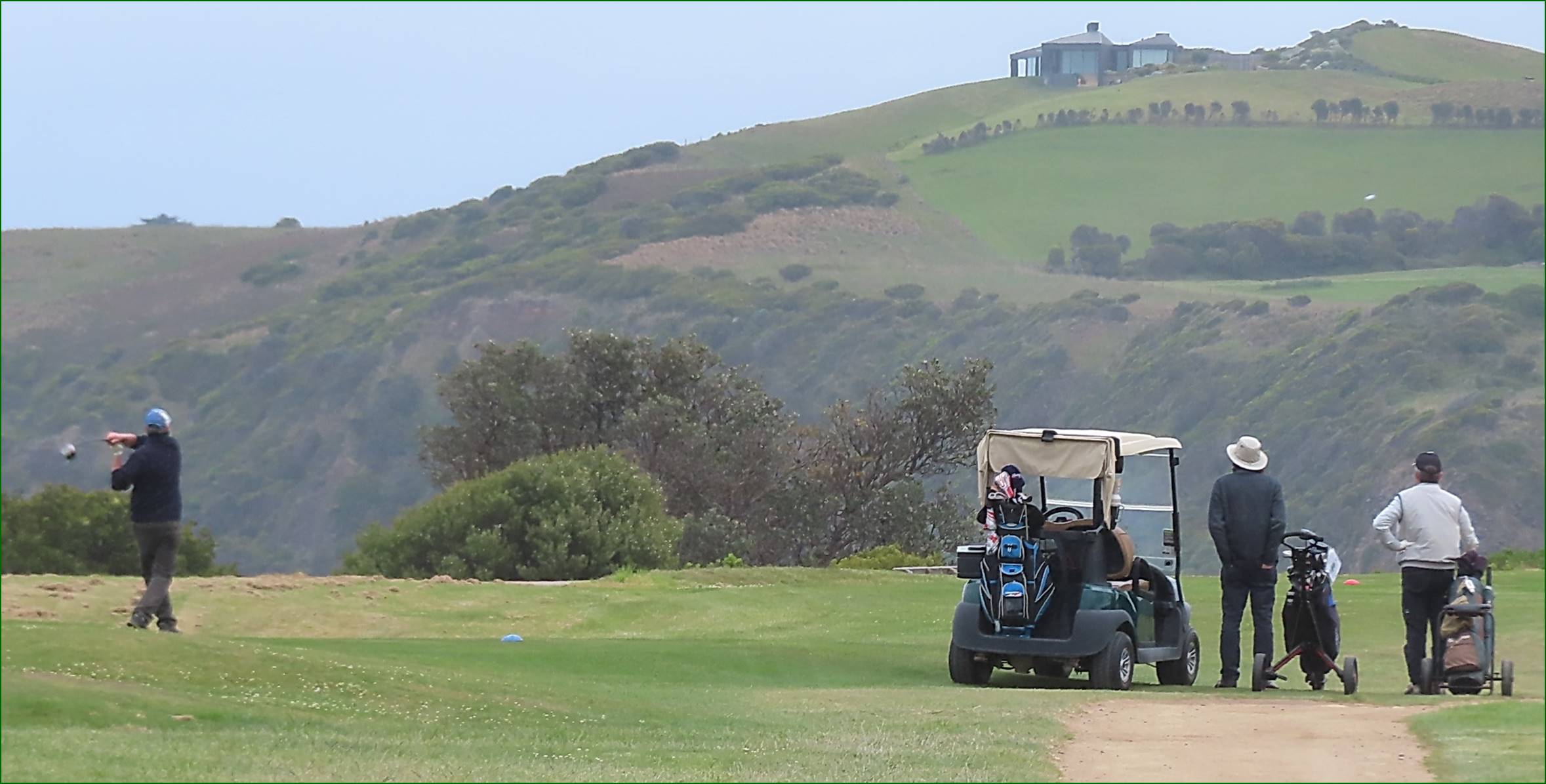 A golf cart on a golf course

Description automatically generated