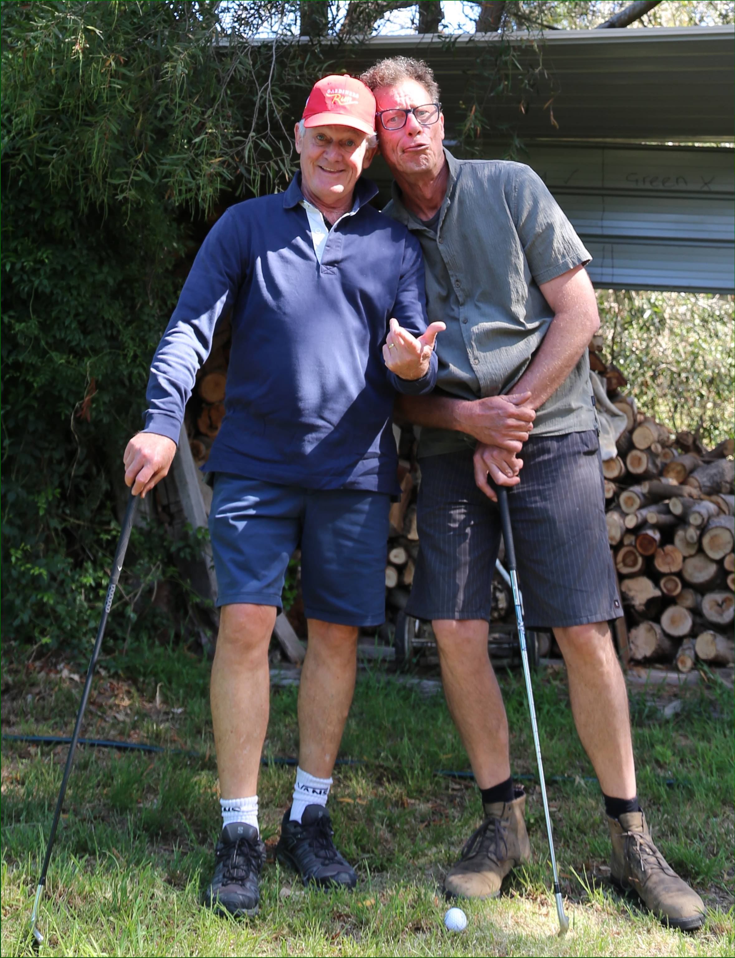 Two men standing next to each other

Description automatically generated
