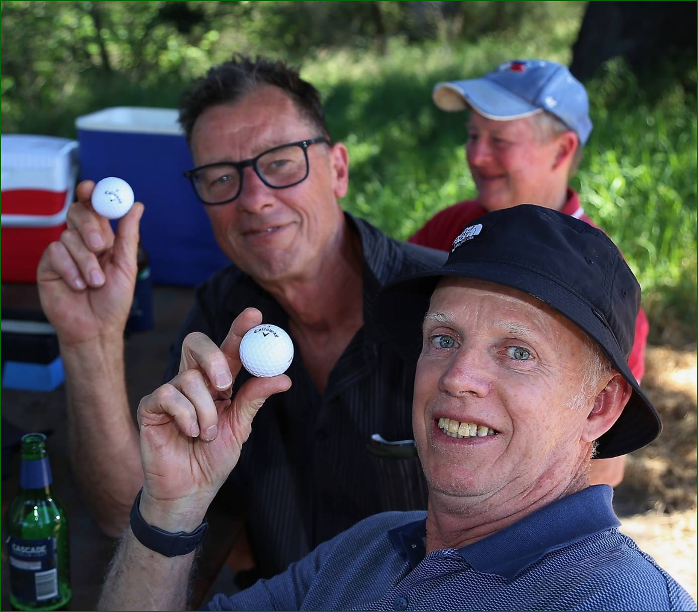 A group of men holding golf balls

Description automatically generated