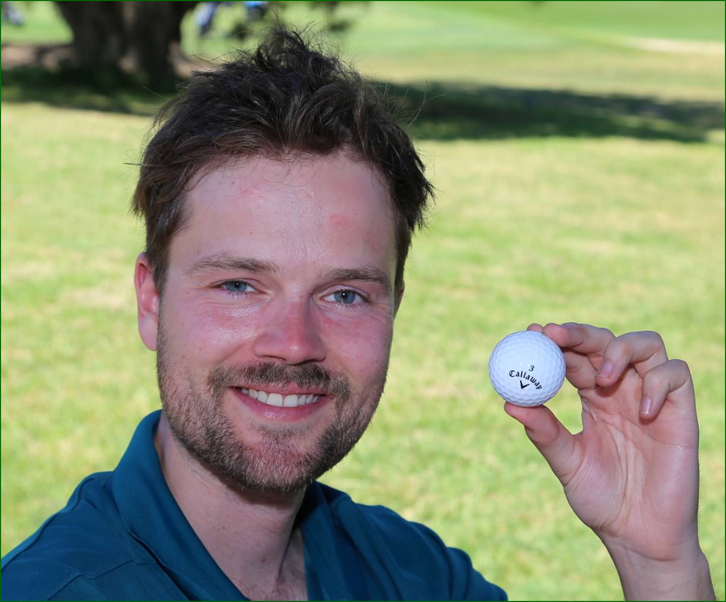 A person holding a golf ball

Description automatically generated