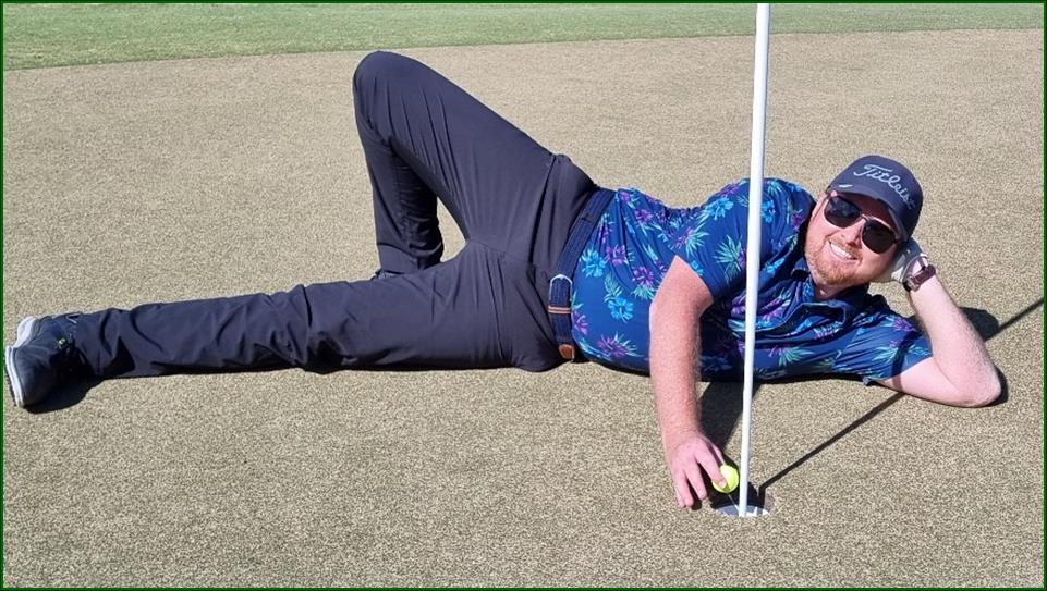 A person lying on the ground with a golf ball

Description automatically generated