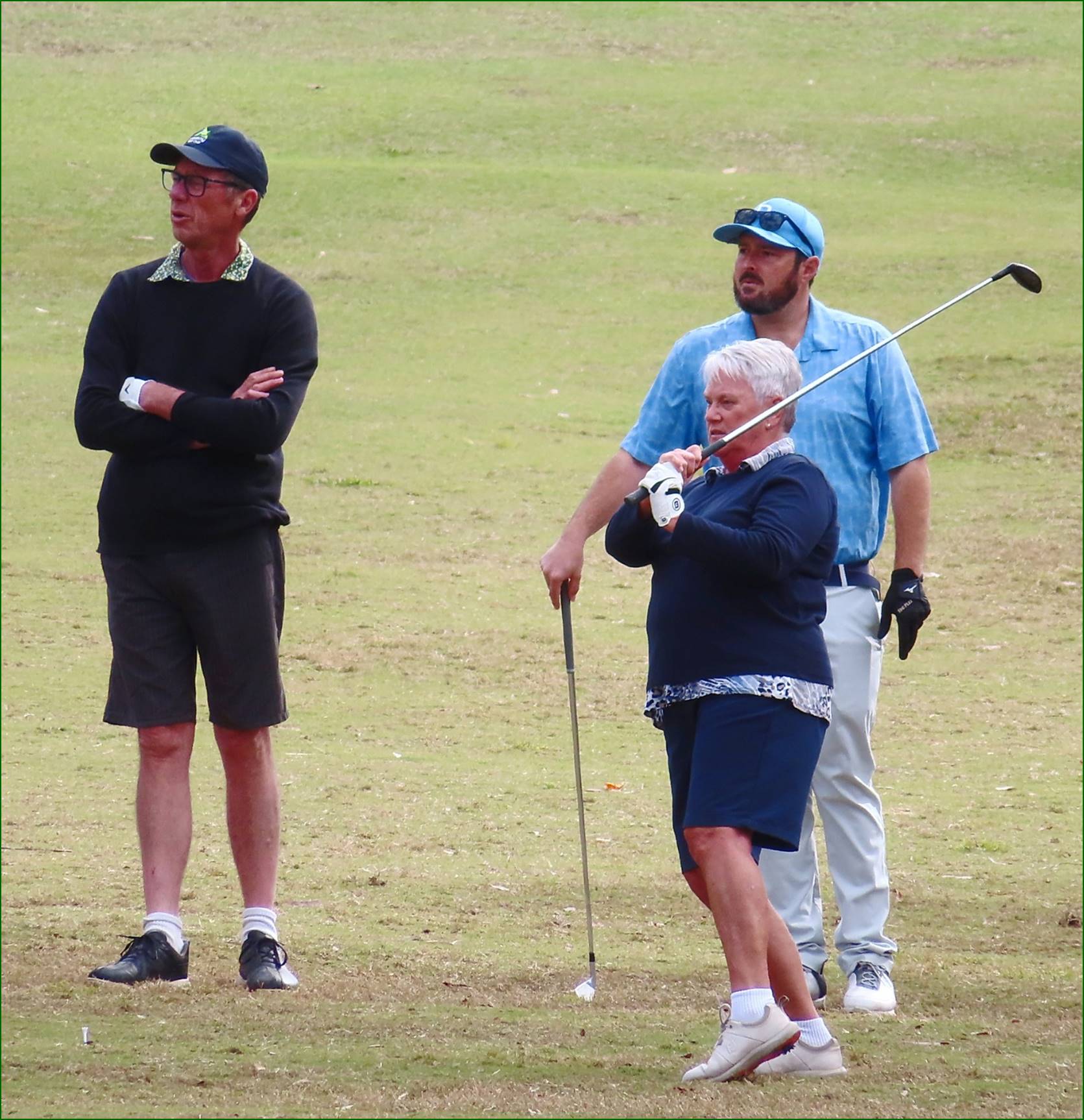 A group of people on a golf course

Description automatically generated
