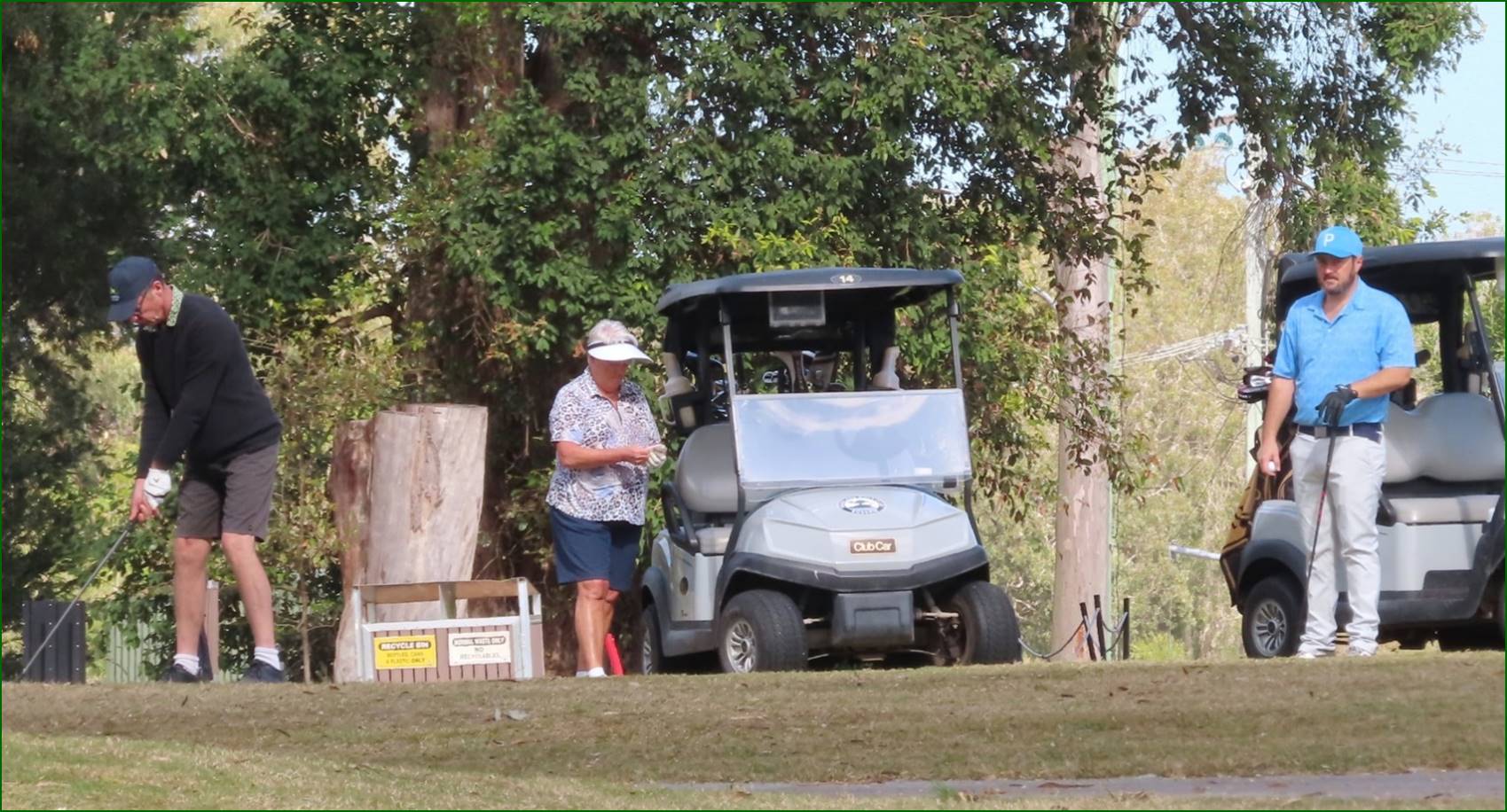 A person standing next to a golf cart

Description automatically generated