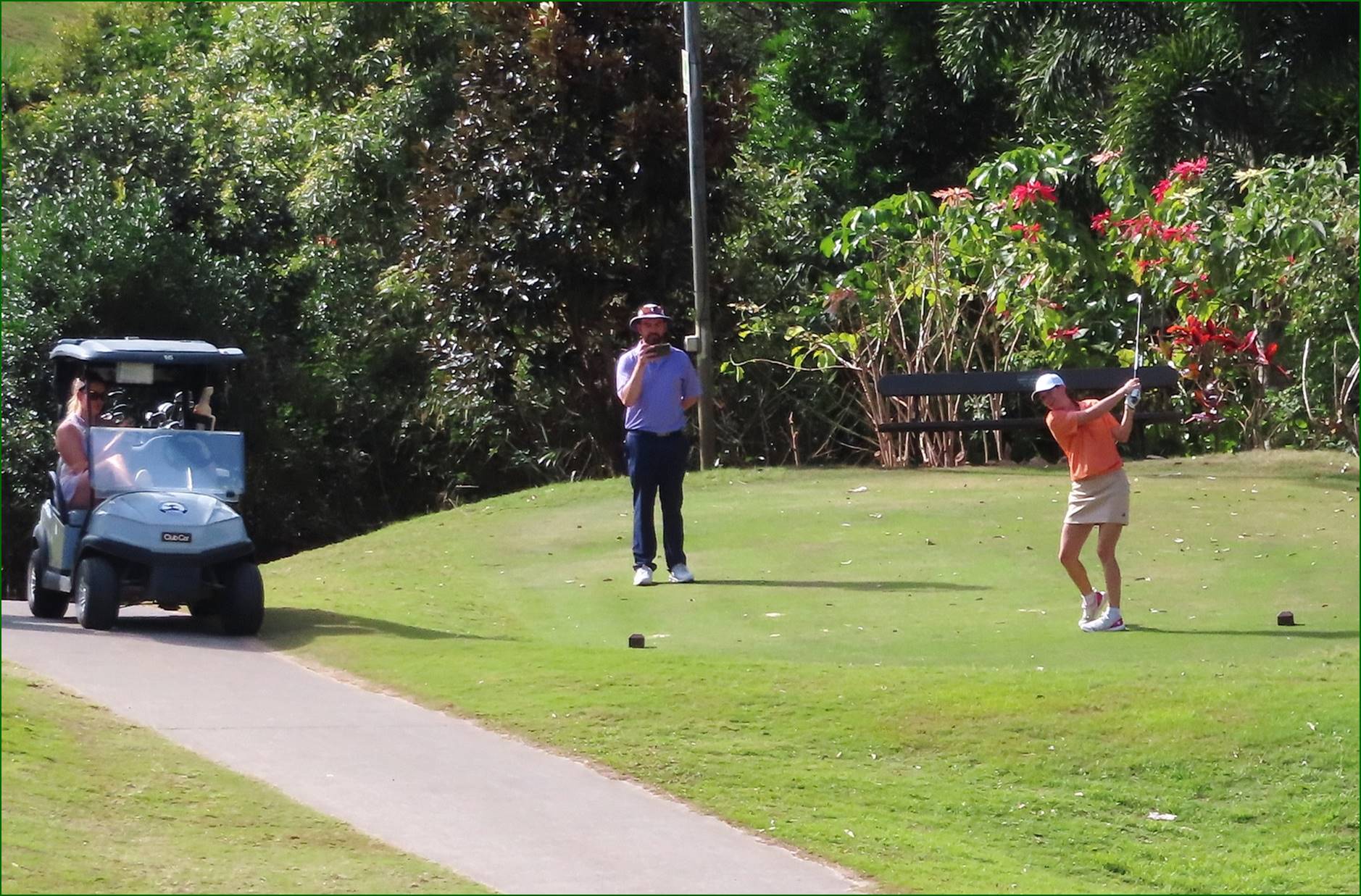 A group of people playing golf

Description automatically generated