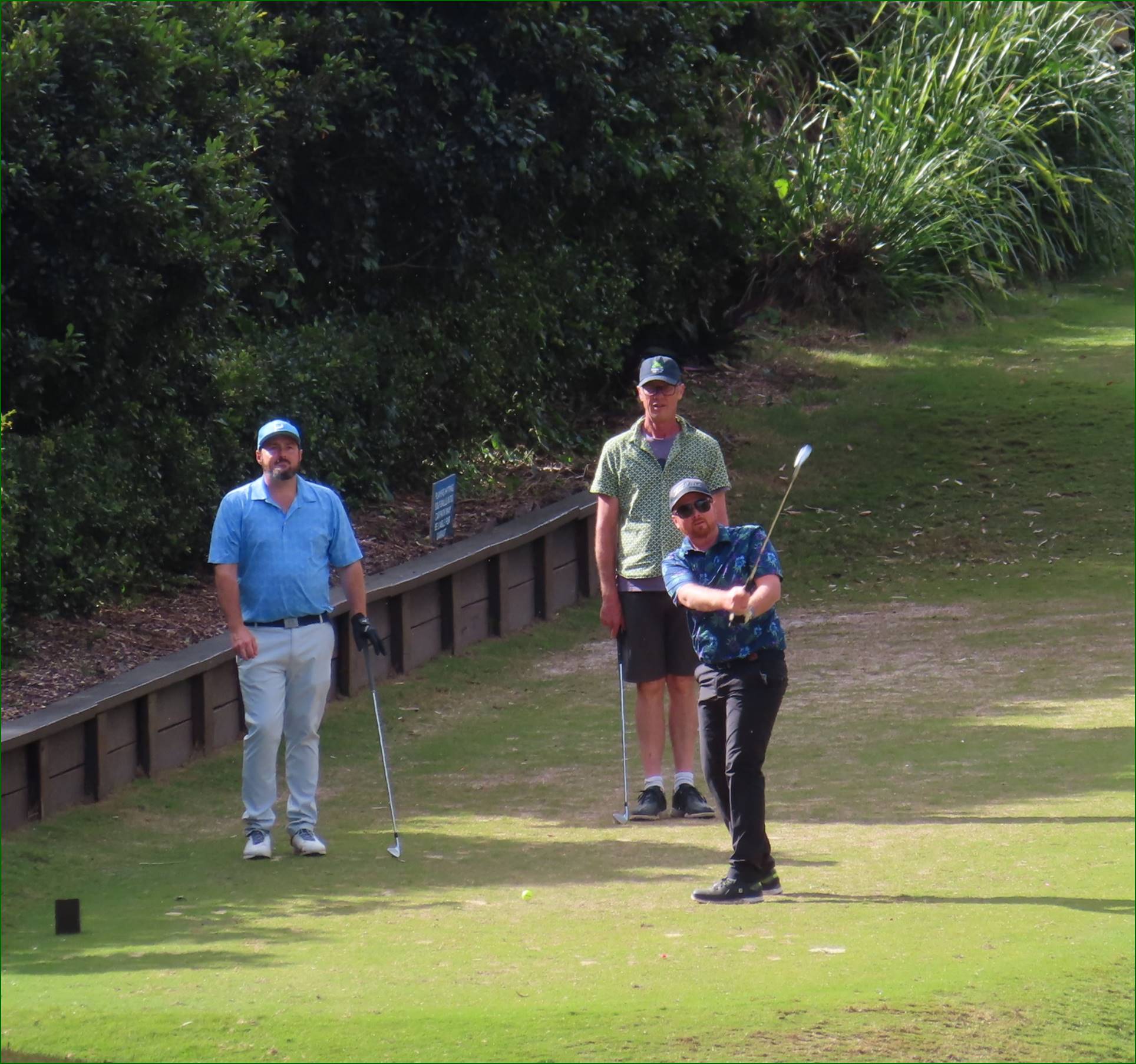 A group of men playing golf

Description automatically generated