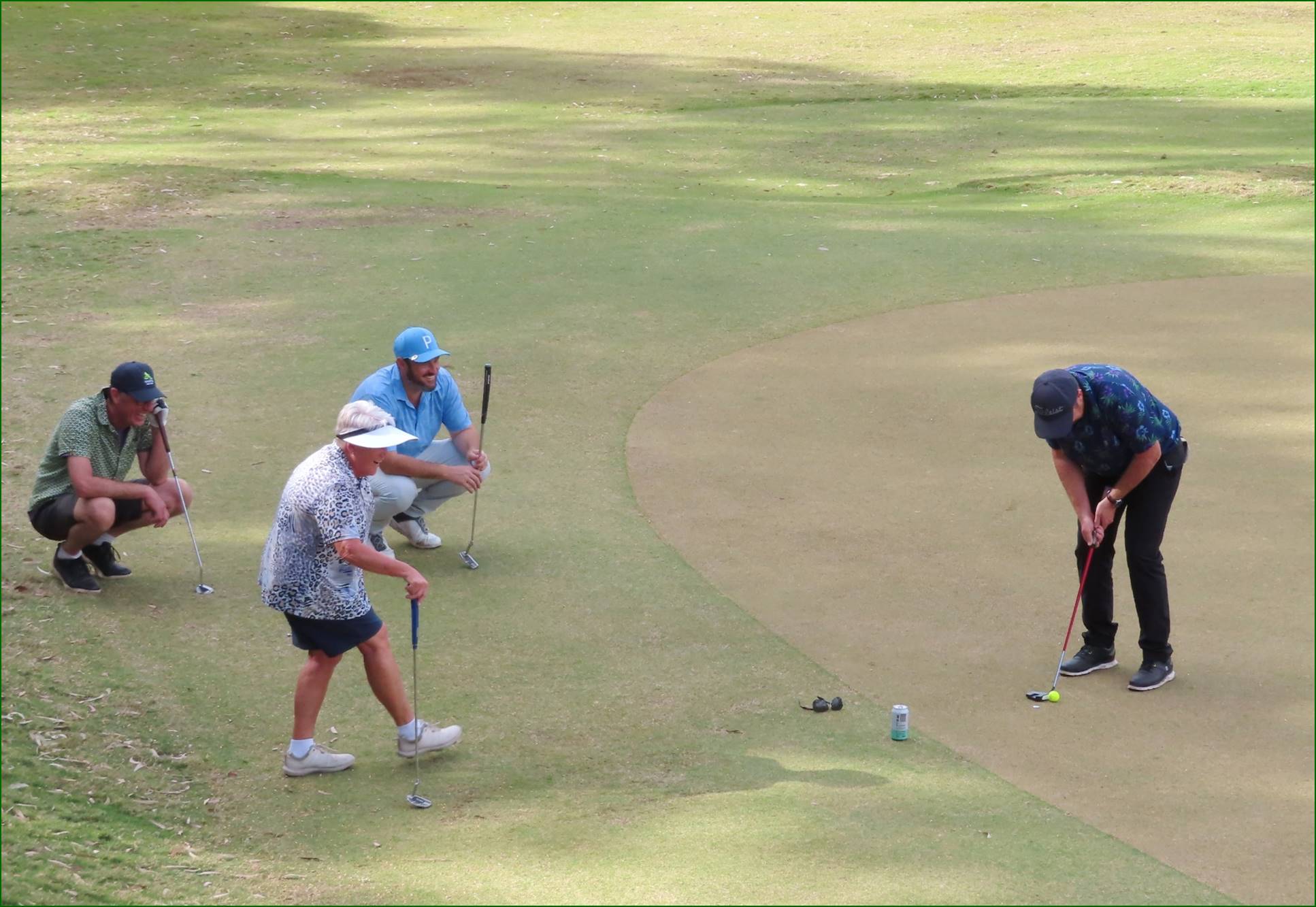 A group of people playing golf

Description automatically generated