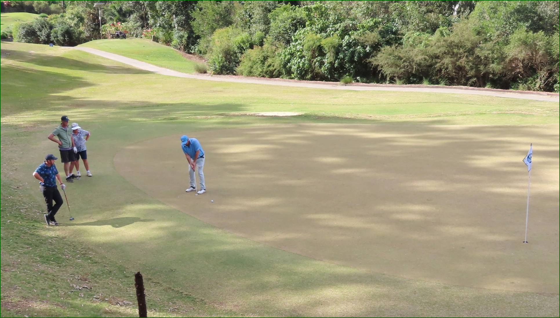A person playing golf on a golf course

Description automatically generated