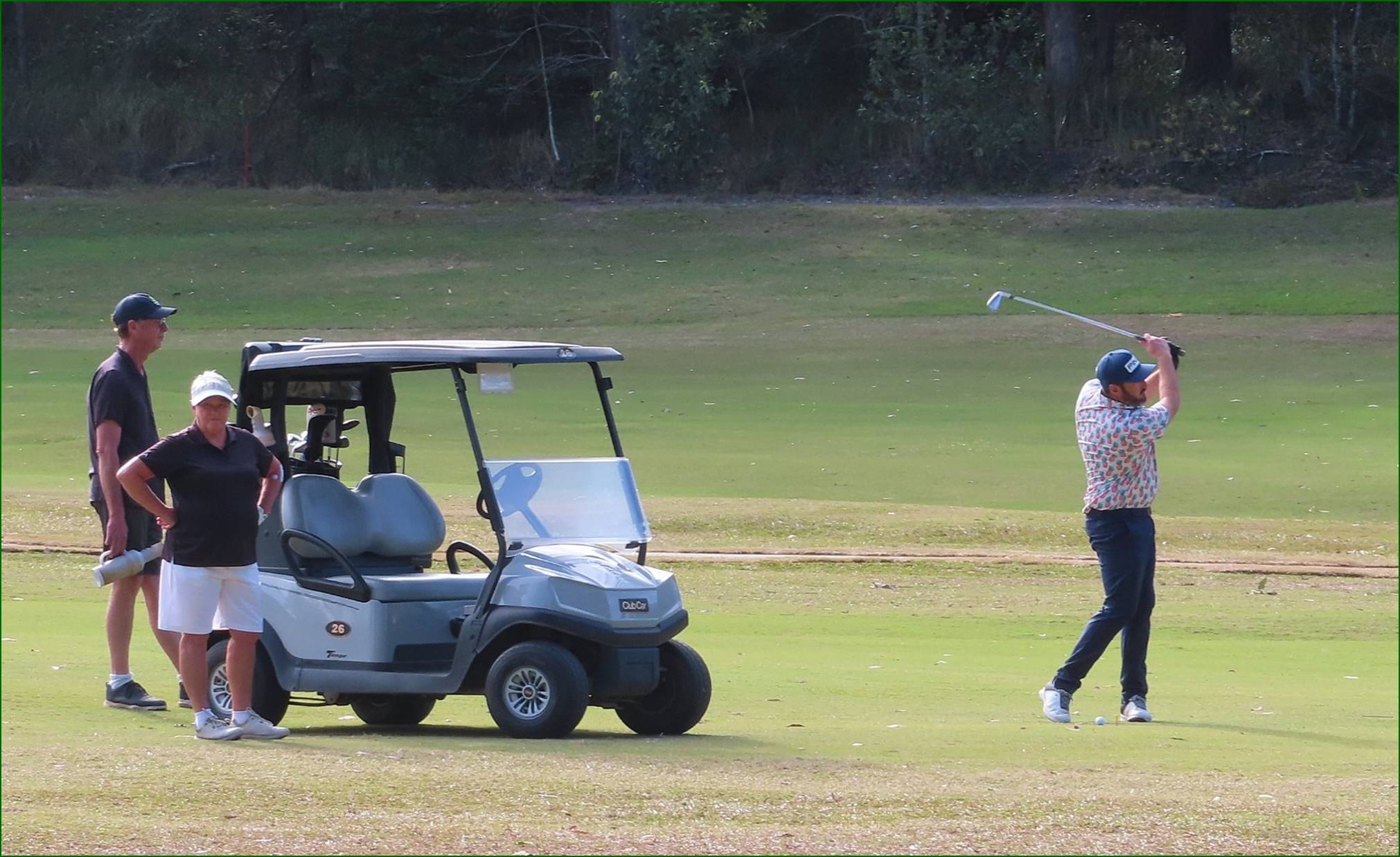 A group of people playing golf

Description automatically generated