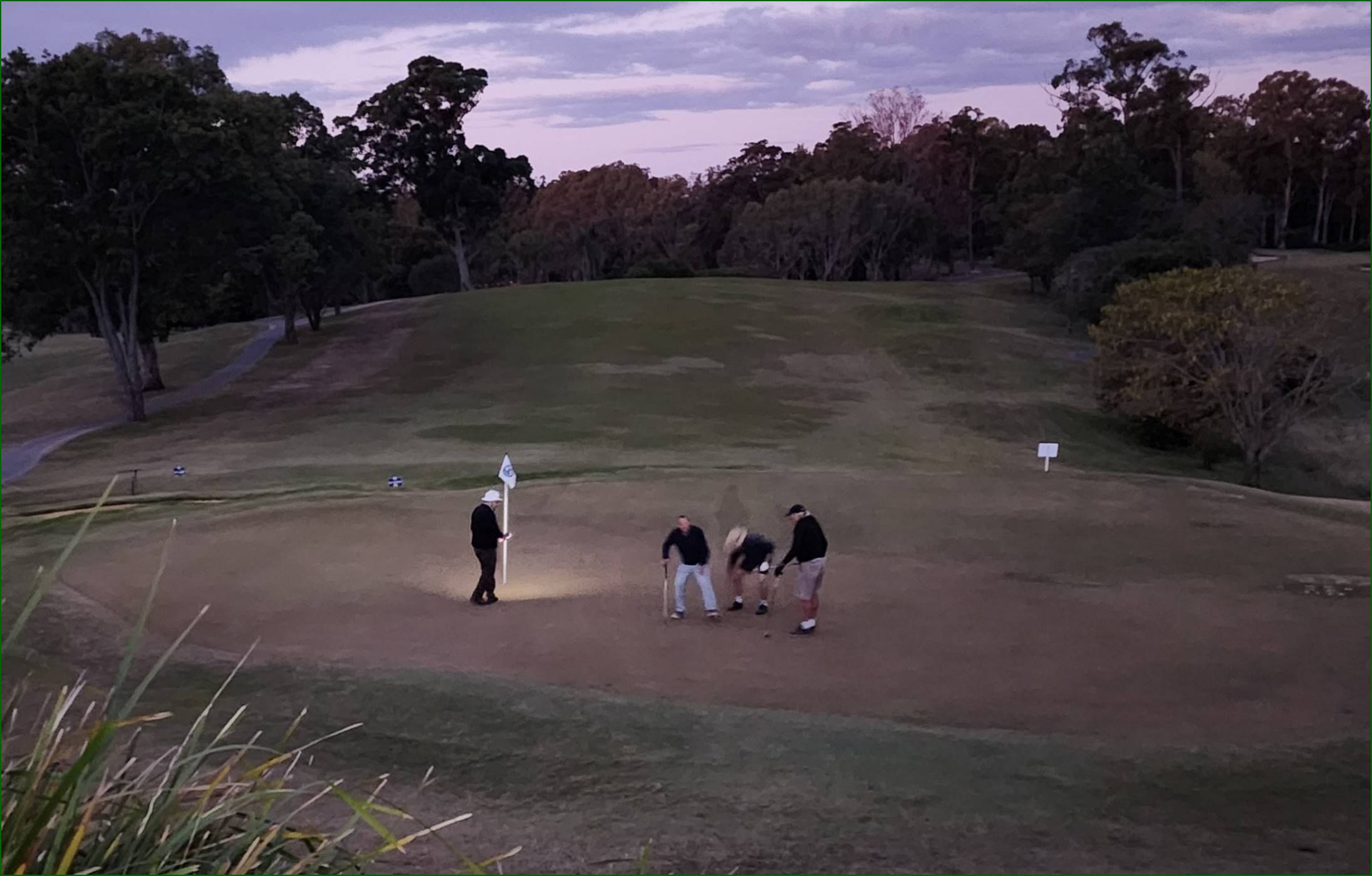 A group of people playing golf

Description automatically generated