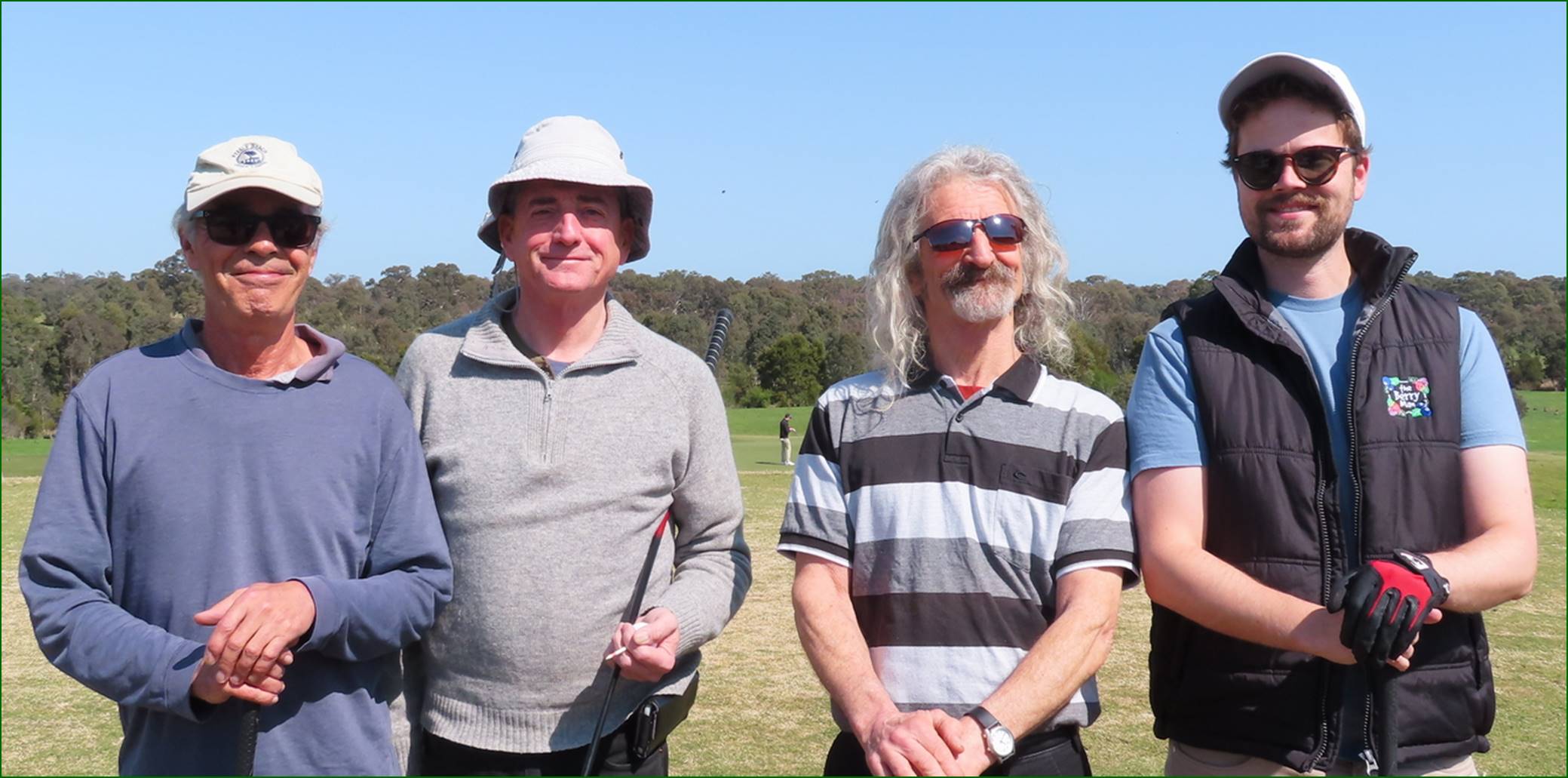 A group of men standing in a field

Description automatically generated