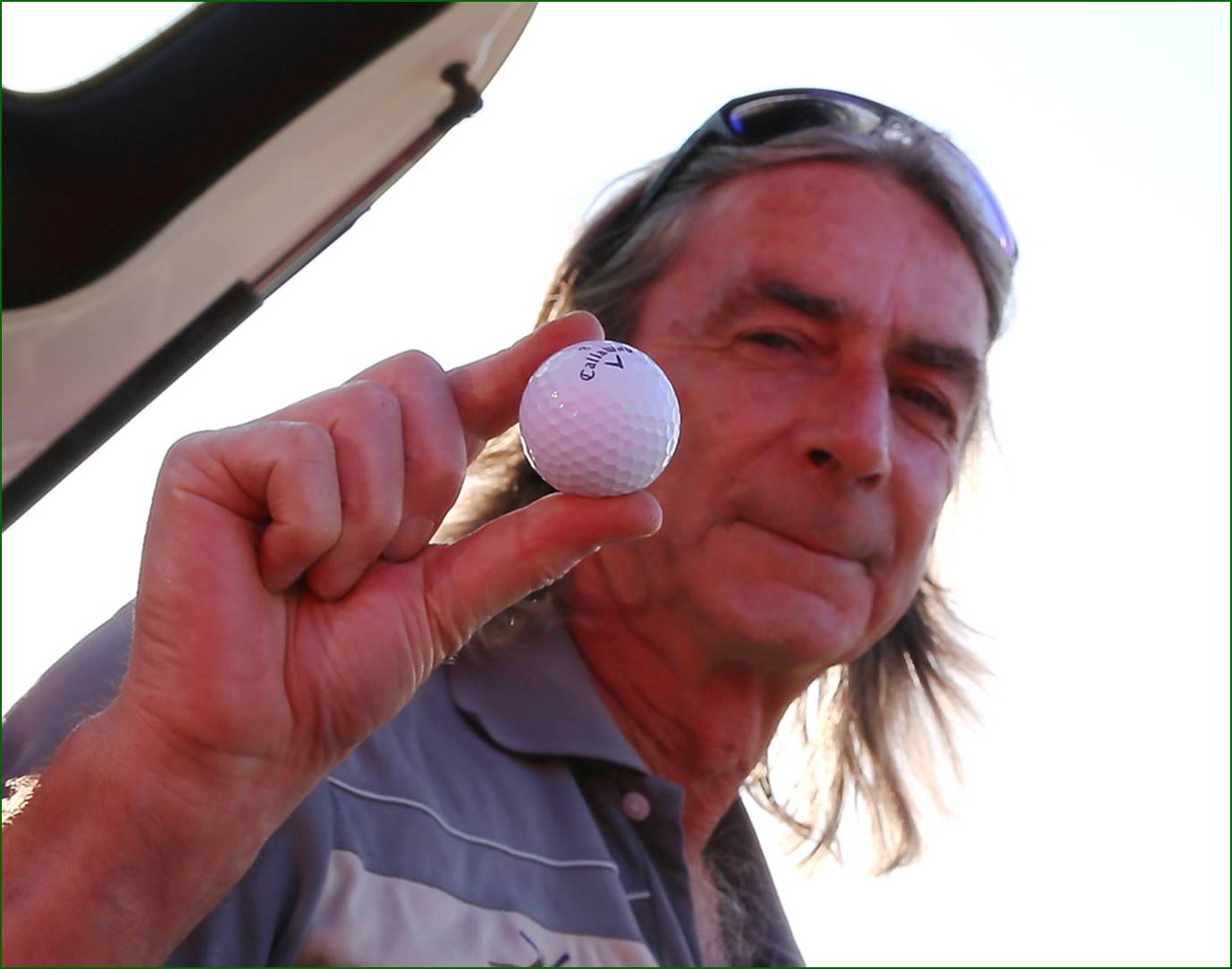 A person holding a golf ball

Description automatically generated