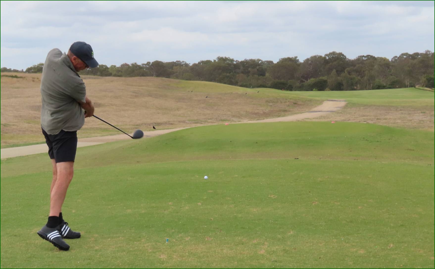 A person playing golf on a golf course

AI-generated content may be incorrect.