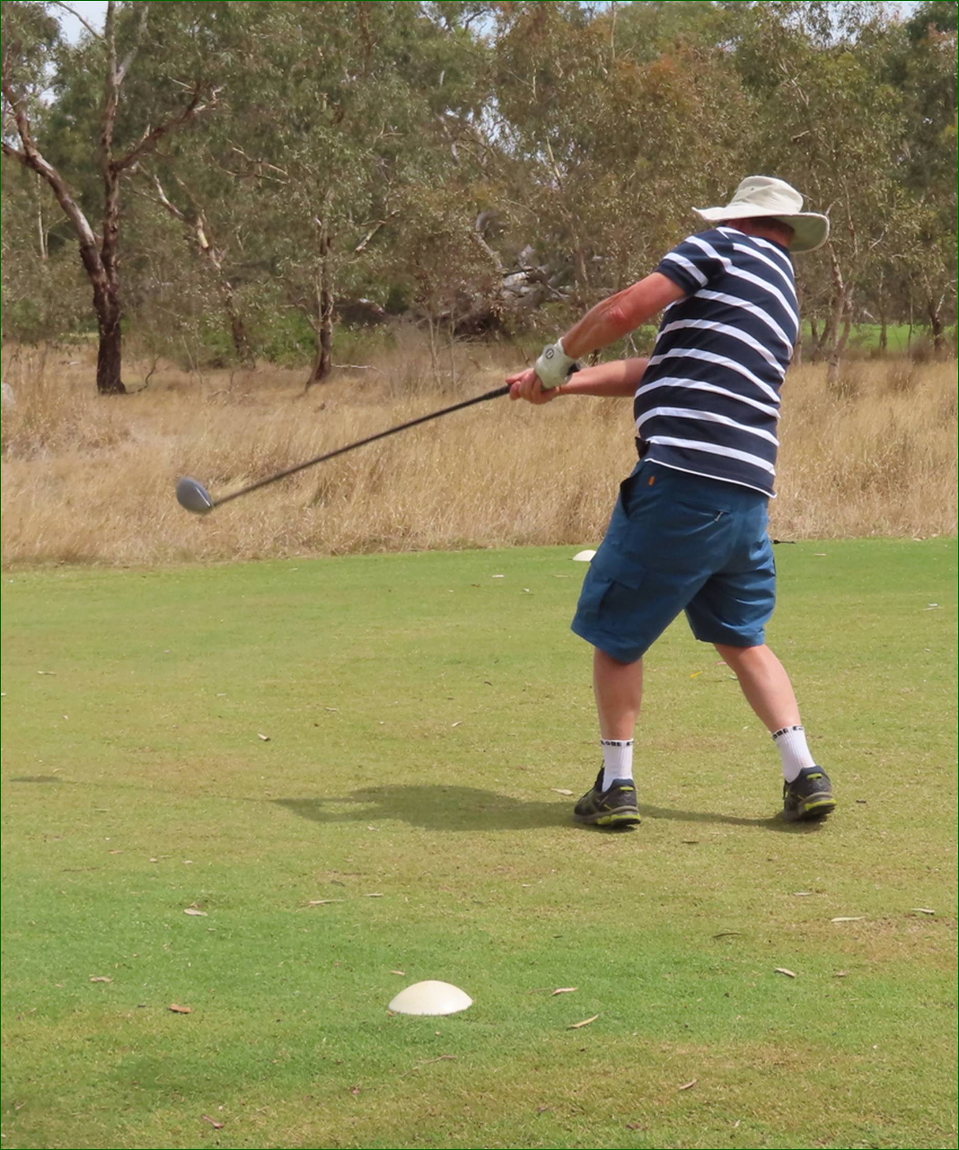 A person swinging a golf club

AI-generated content may be incorrect.