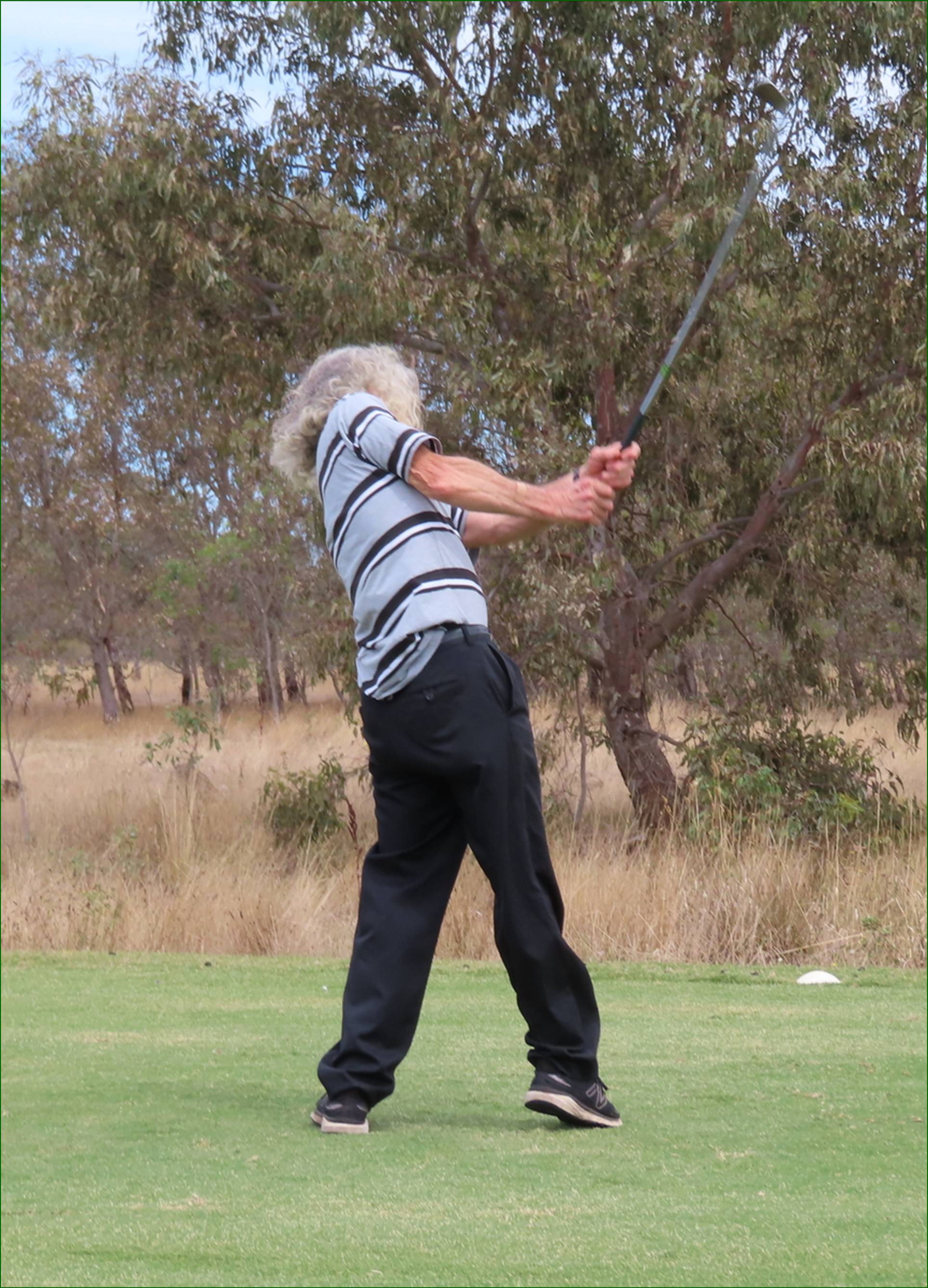A person swinging a golf club

AI-generated content may be incorrect.