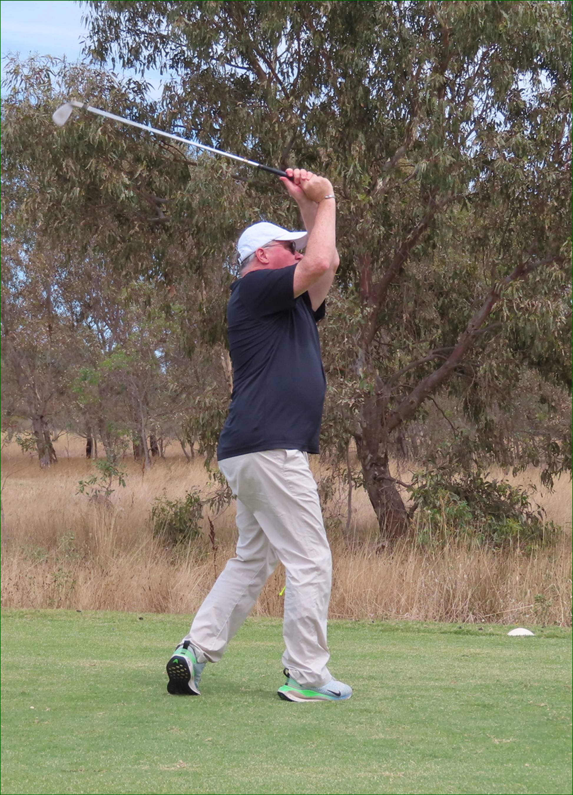 A person swinging a golf club

AI-generated content may be incorrect.