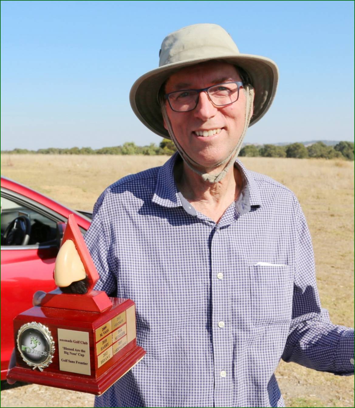 A person holding a trophy

Description automatically generated