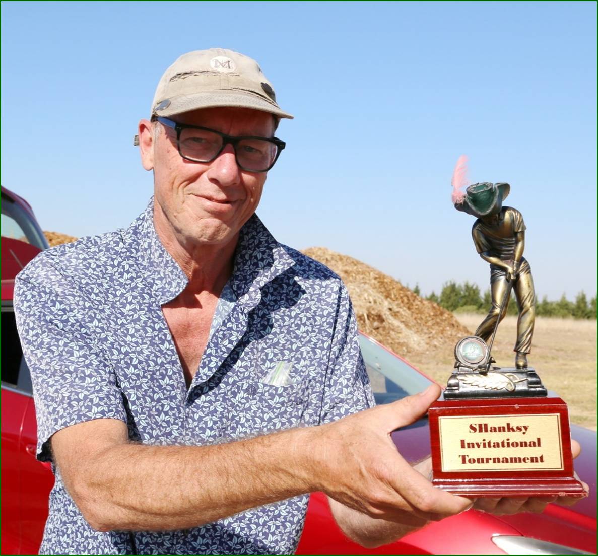 A person holding a trophy

Description automatically generated